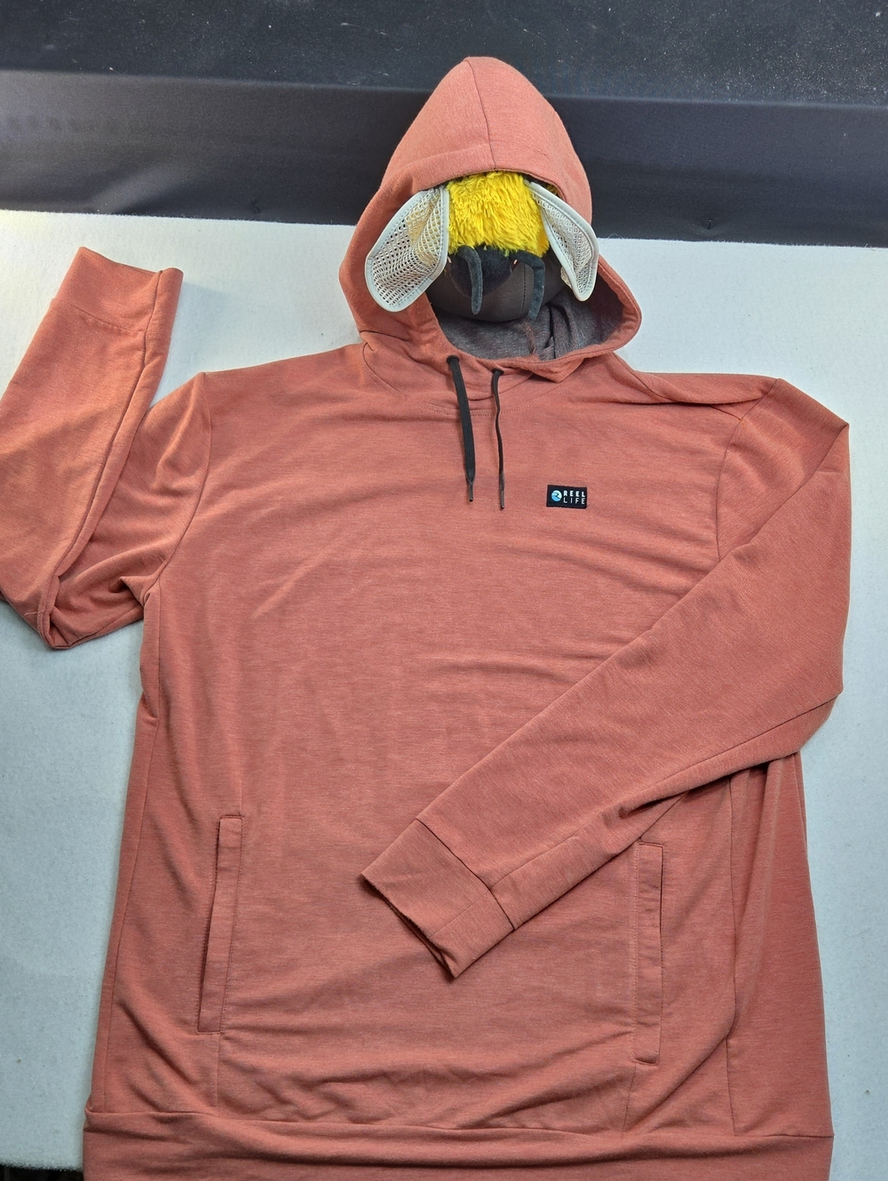 Reel Life Destin Heathered Pullover Hoodie in a salmon/spicy orange colorway